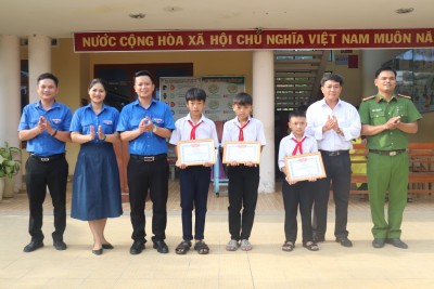 Lãnh đạo Thị Đoàn, Hội đồng Đội thị xã, Ban Giám hiệu nhà trường và Công an xã tuyên dương 3 em học sinh tại lễ chào cờ